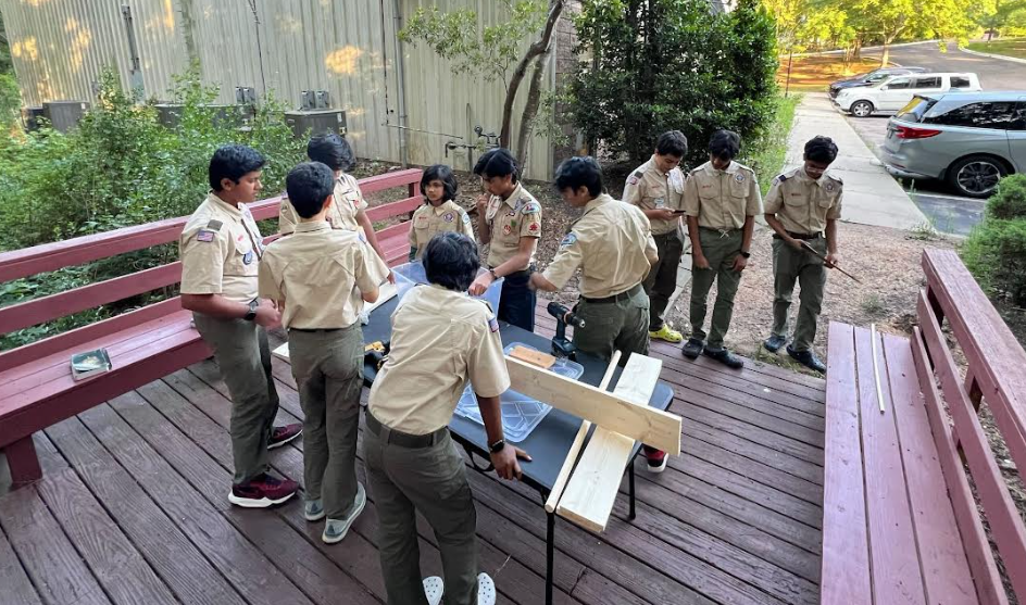Scouts building a knot-tying station to practice with.